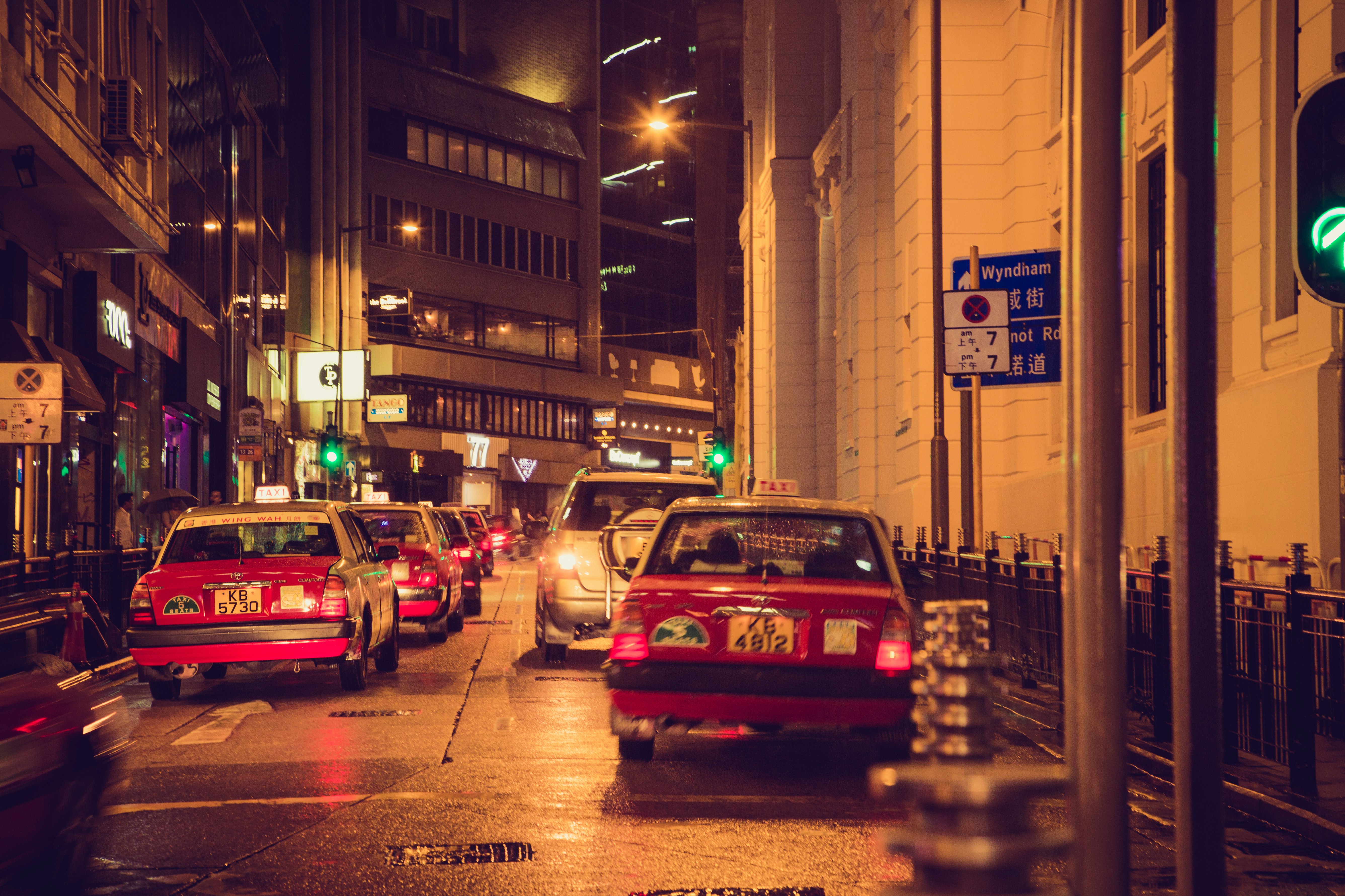 red and white cars on road during night time